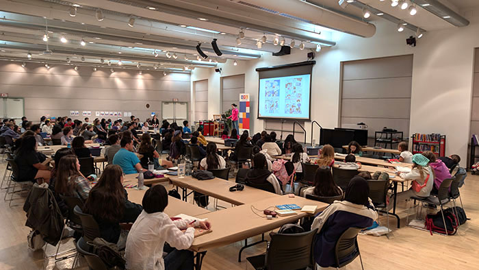 Mei Yu voice acting part of her graphic novel memoir Lost & Found at her keynote presentation at the VPL Writing and Book Camp 2025.