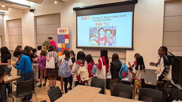 Mei Yu signing autographs after her keynote presentation at the VPL Writing and Book Camp 2025.