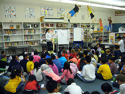 Mei teaching students a drawing lesson.